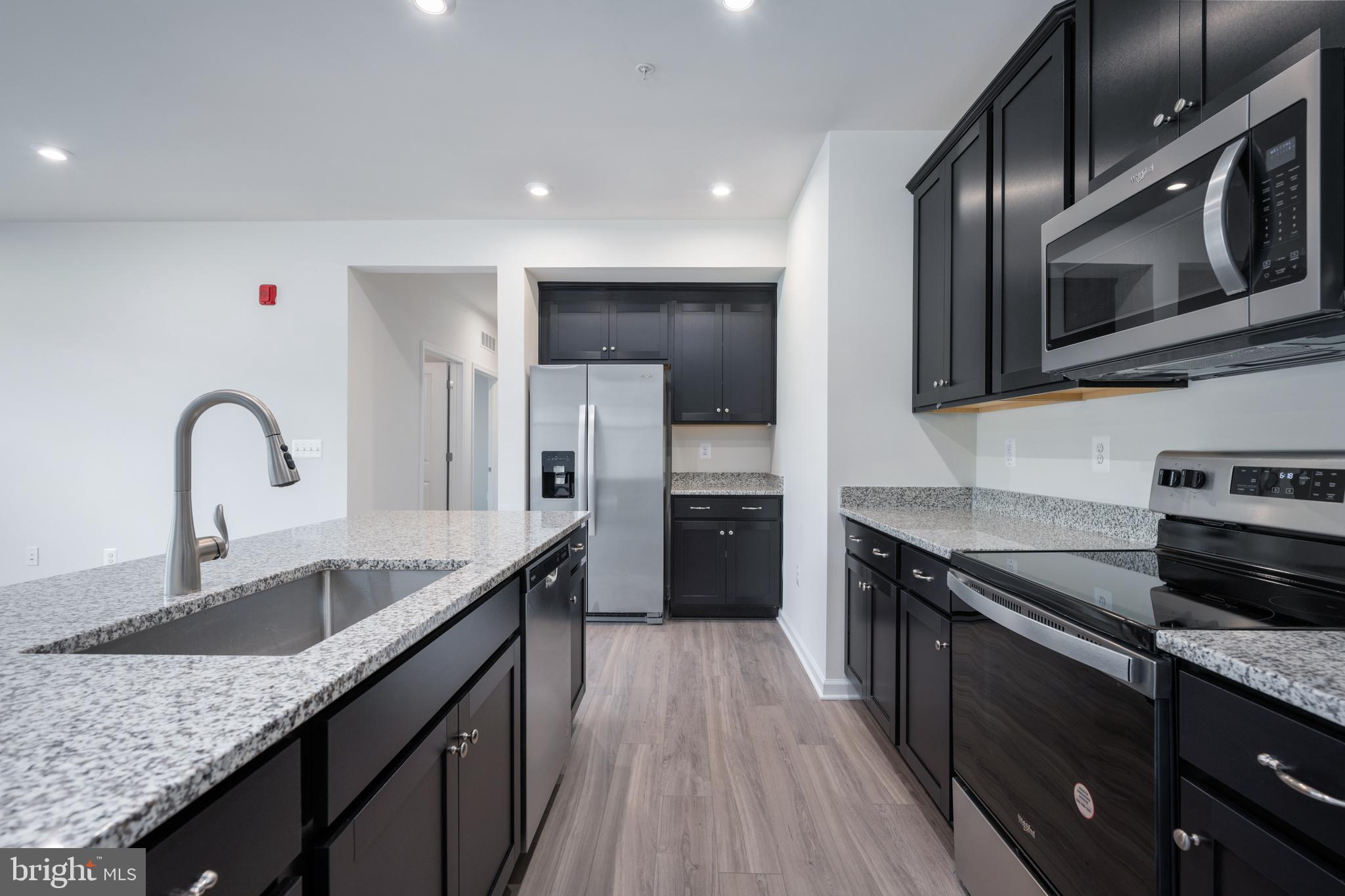 29 Hyssop Way, Unit 101 Stafford, VA 22554 - Photo 18 of 34 a kitchen with stainless steel appliances granite countertop a sink stove and refrigerator