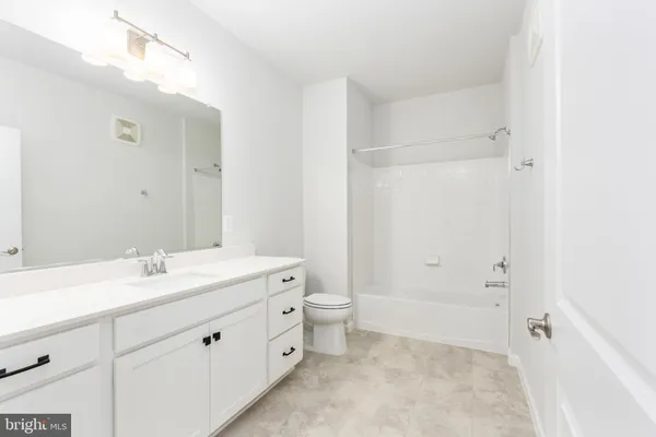 a bathroom with a double vanity sink and mirror