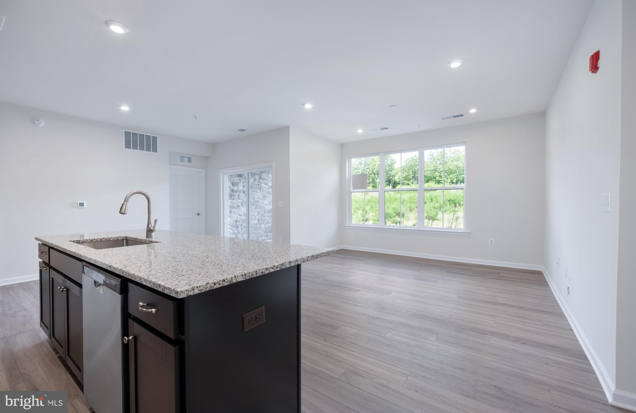 29 Hyssop Way, Unit 101 Stafford, VA 22554 - Photo 21 of 34 a kitchen with a sink a window and a wooden floor