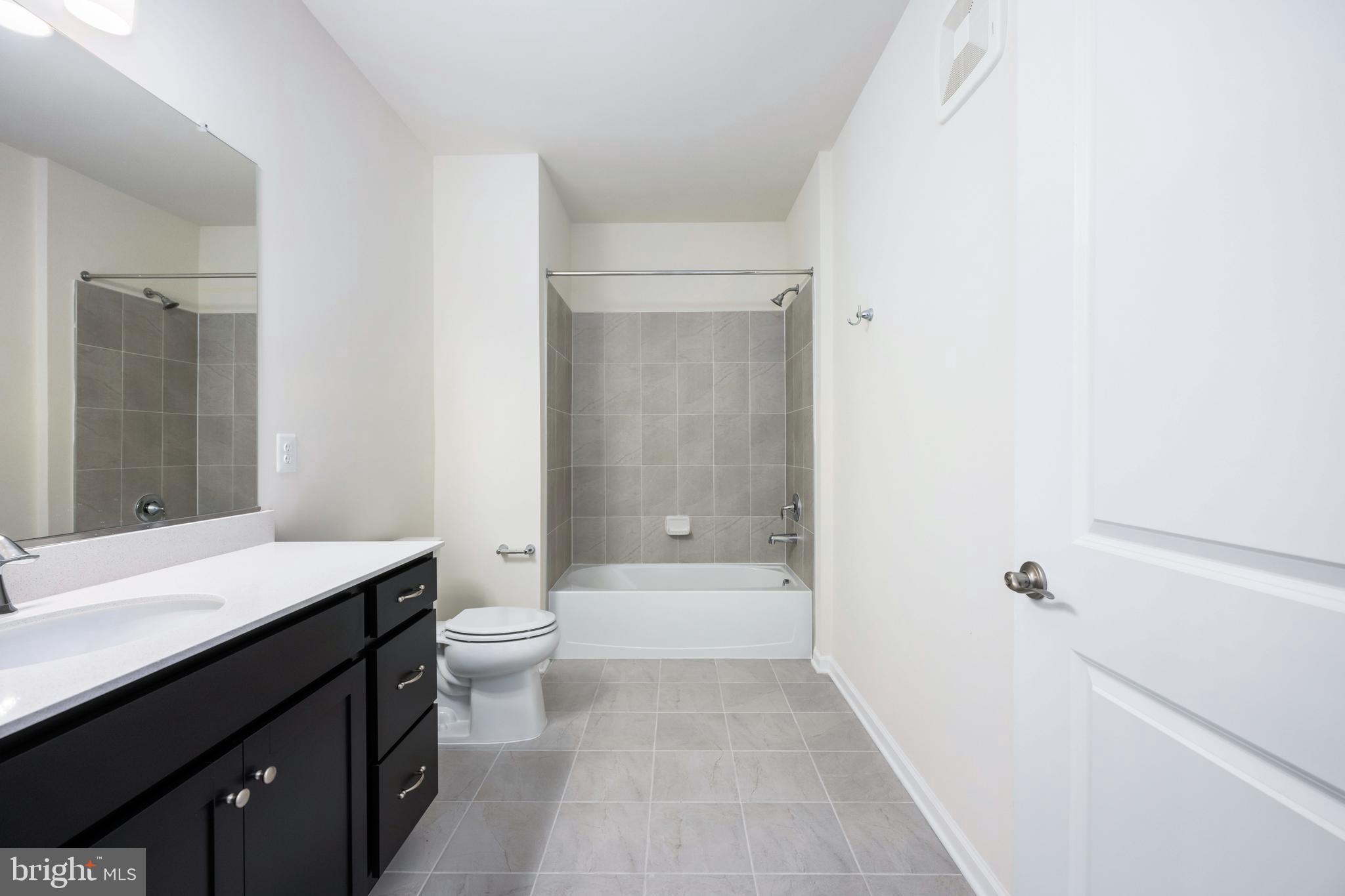 29 Hyssop Way, Unit 101 Stafford, VA 22554 - Photo 24 of 34 a bathroom with a sink a toilet and shower
