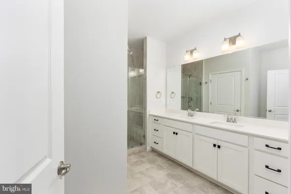 a bathroom with a sink vanity and a mirror