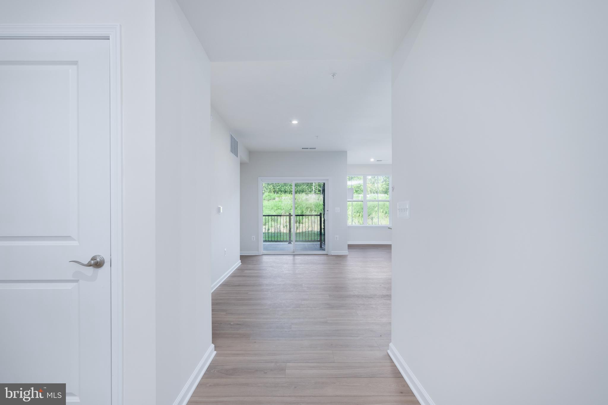 29 Hyssop Way, Unit 101 Stafford, VA 22554 - Photo 8 of 34 a view of a hallway with wooden walls and a window