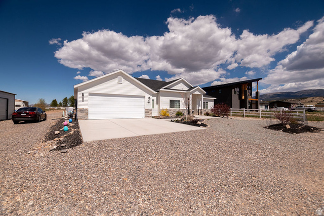 745 East 885 North Beaver, UT 84713 - Photo 3 of 50 View of front of property with concrete driveway, stone siding, and a porch