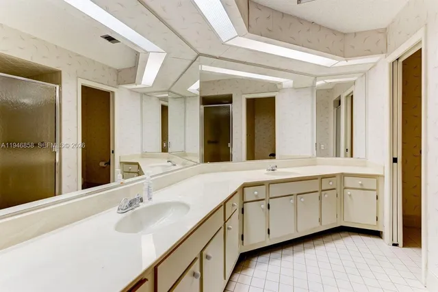 a bathroom with a double vanity sink and mirror