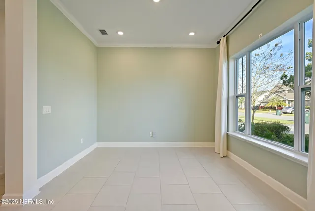 a large kitchen with stainless steel appliances kitchen island granite countertop a refrigerator a sink and a stove