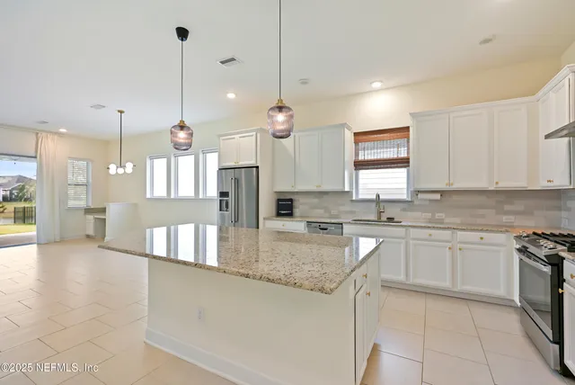 a stove top oven sitting inside of a kitchen