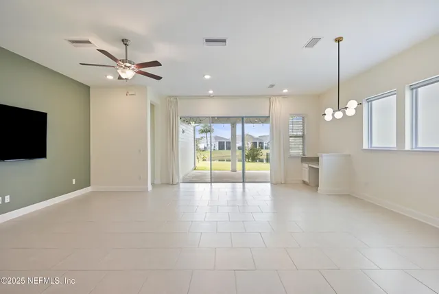 a view of a kitchen with a refrigerator and microwave
