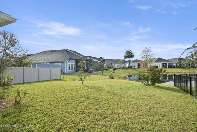 a view of a lake with houses in the background