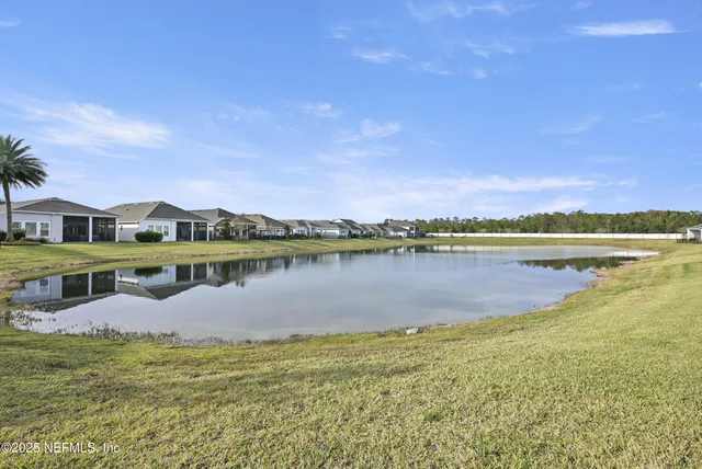 an aerial view of residential houses with outdoor space and swimming pool