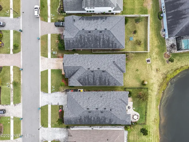 an aerial view of a house with a garden and swimming pool