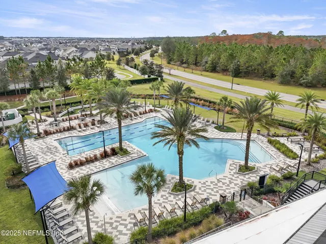 a living room with furniture and floor to ceiling windows