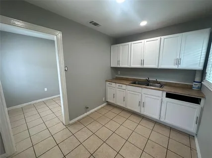 a kitchen with a sink and cabinets