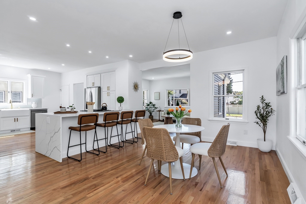 24 Ballard Street Saugus, MA 01906 - Photo 11 of 38 a view of a dining room and livingroom with furniture wooden floor a chandelier