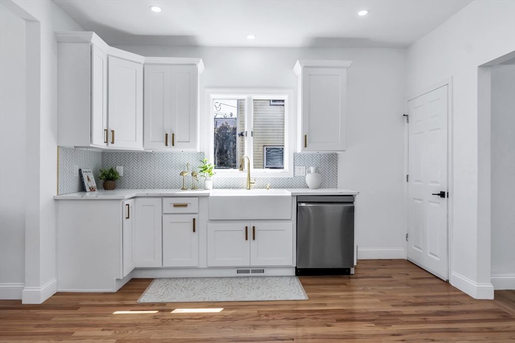 24 Ballard Street Saugus, MA 01906 - Photo 2 of 38 a kitchen with white cabinets and sink