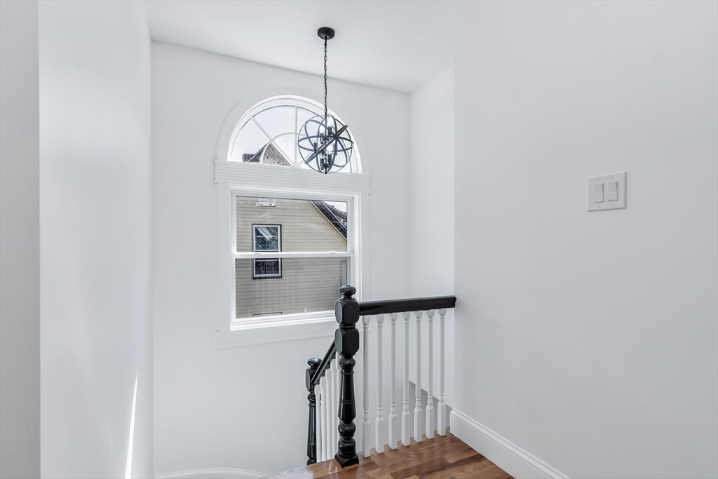 24 Ballard Street Saugus, MA 01906 - Photo 21 of 38 a view of a hallway with a chandelier