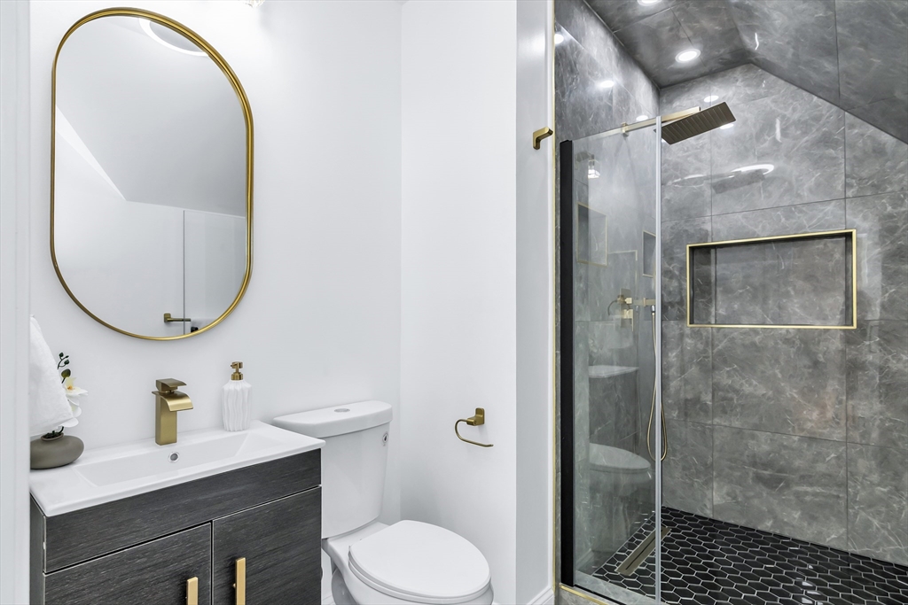 24 Ballard Street Saugus, MA 01906 - Photo 24 of 38 a bathroom with a toilet a sink and a mirror