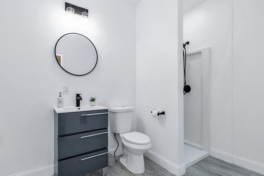 24 Ballard Street Saugus, MA 01906 - Photo 28 of 38 a bathroom with a toilet a sink and a mirror