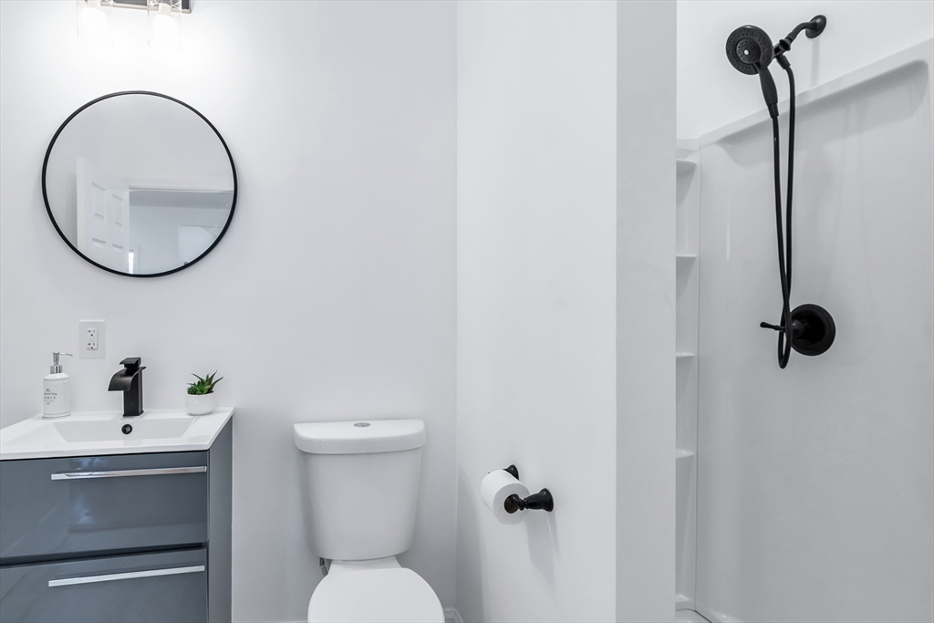 24 Ballard Street Saugus, MA 01906 - Photo 29 of 38 a bathroom with a toilet sink and mirror