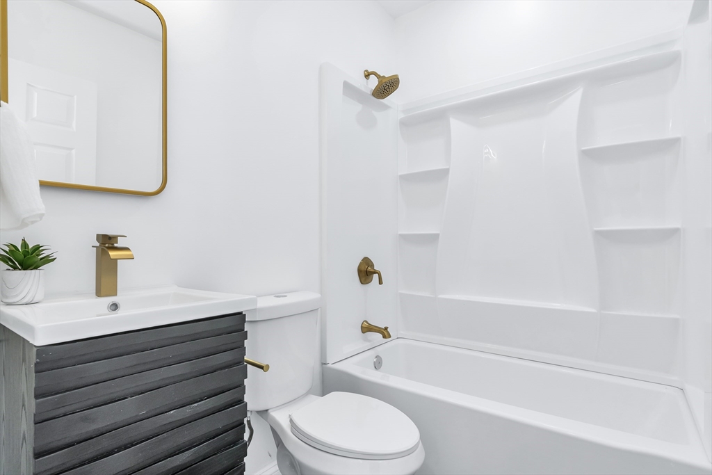 24 Ballard Street Saugus, MA 01906 - Photo 30 of 38 a bathroom with a sink a toilet and a bathtub