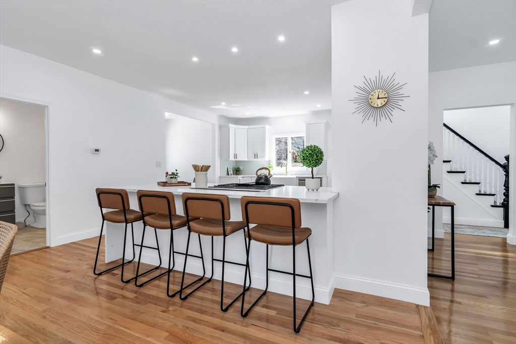 24 Ballard Street Saugus, MA 01906 - Photo 10 of 38 a kitchen with granite countertop a dining table chairs and a potted plant