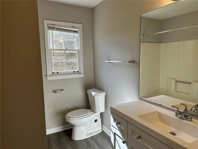 a bathroom with a sink toilet and window