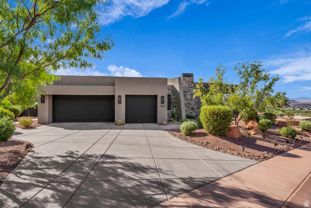 2047 Cougar Rock Circle St. George, UT 84770 - Photo 1 of 1 View of front of house featuring stucco siding, driveway, and an attached garage
