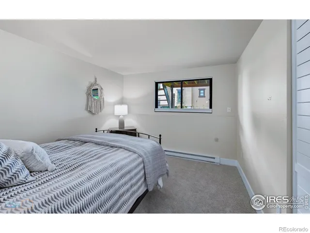 a bedroom with a bed and a painting