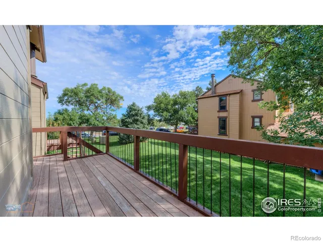 a view of a balcony with wooden floor