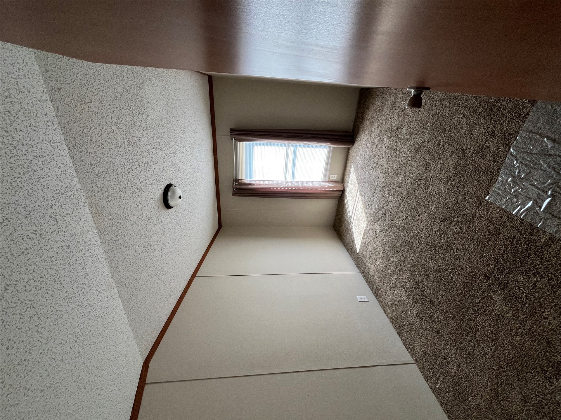 428628 East 1133 Road Porum, OK 74455 - Photo 11 of 16 Neutral wall paneling, flush mount ceiling light fixture, brown textured carpeting, and a single window with curtain rods