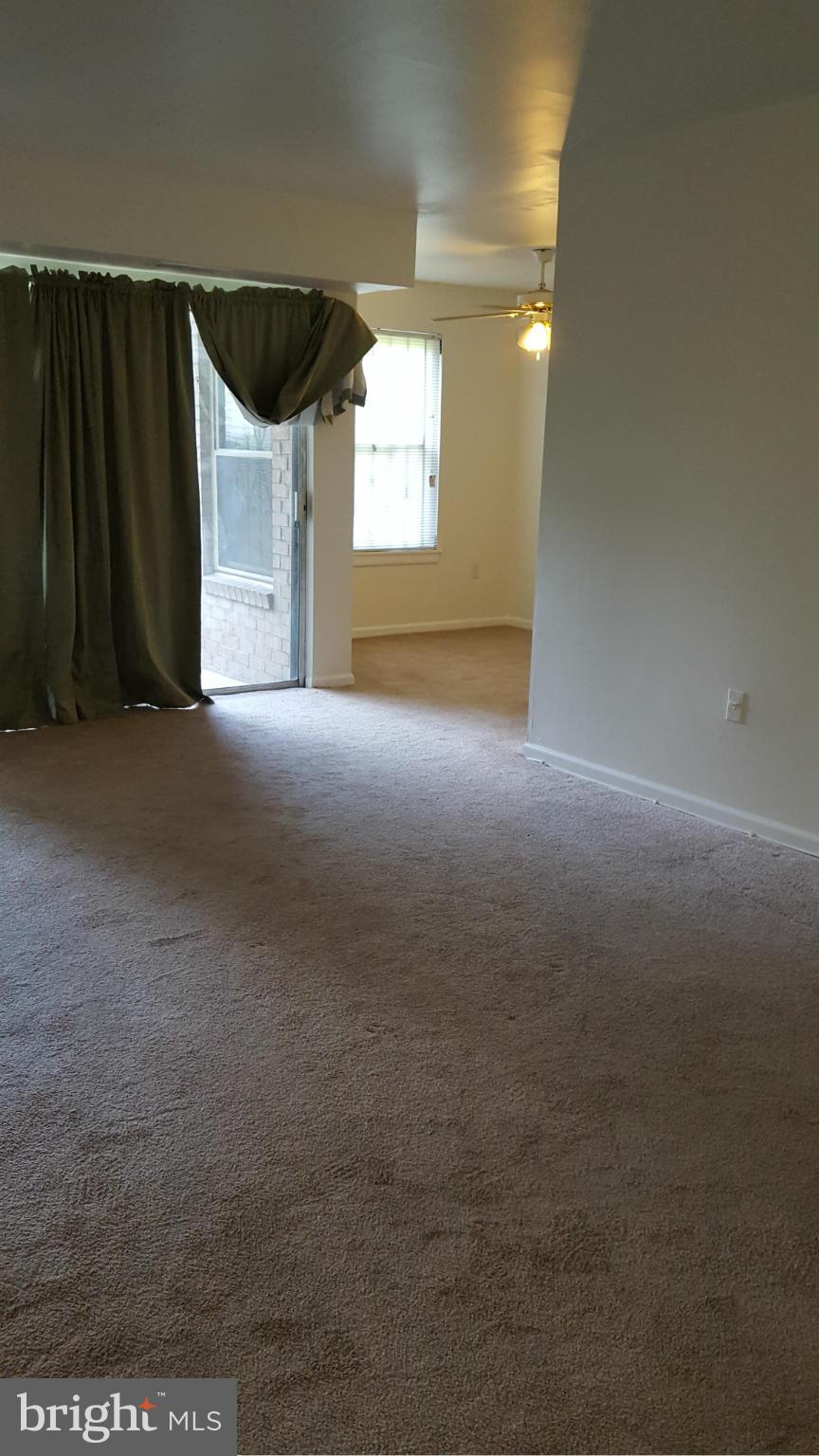 3845 St Barnabas Road, Unit T Suitland, MD 20746 - Photo 4 of 8 a view of a big room with windows and fireplace