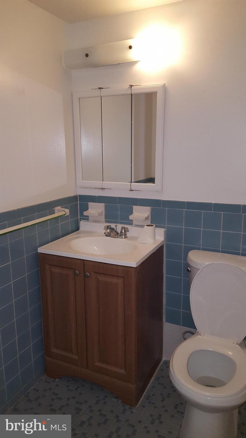3845 St Barnabas Road, Unit T Suitland, MD 20746 - Photo 5 of 8 a bathroom with a sink a toilet and a mirror