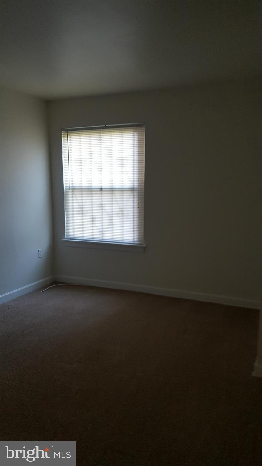 3845 St Barnabas Road, Unit T Suitland, MD 20746 - Photo 8 of 8 a view of an empty room with a window
