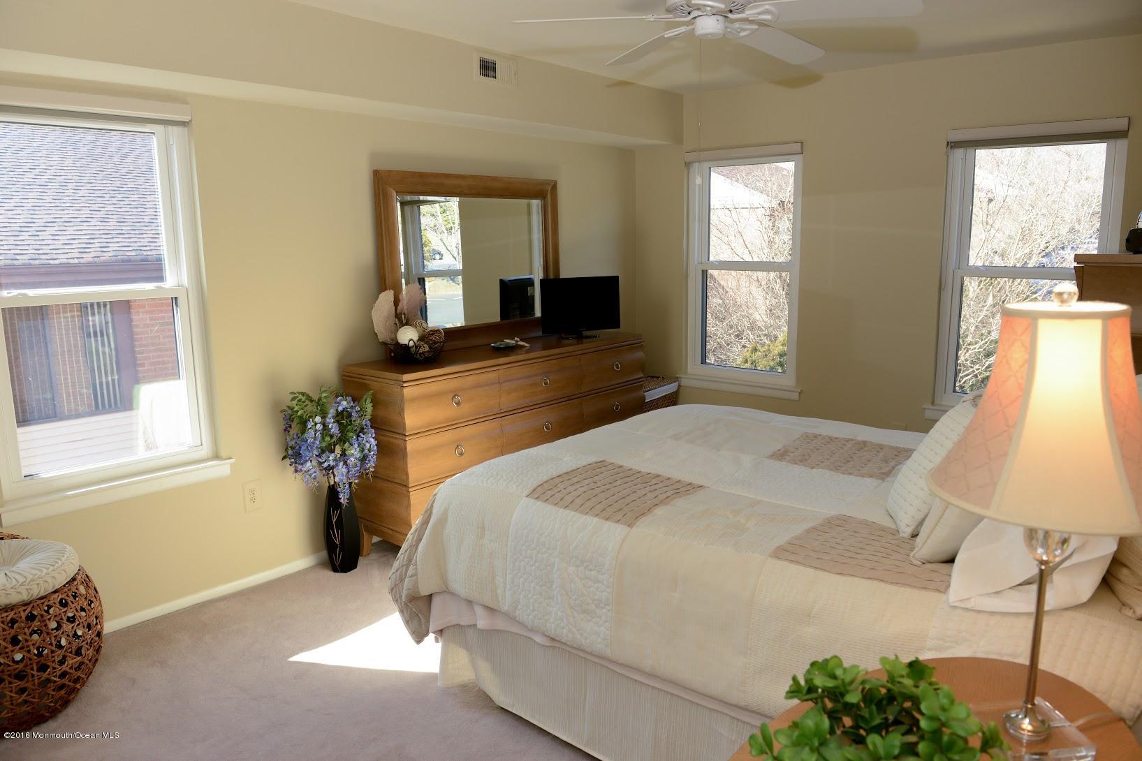 200 Portland Road, Unit A24 Highlands, NJ 07732 - Photo 14 of 30 a bedroom with a bed and a chandelier