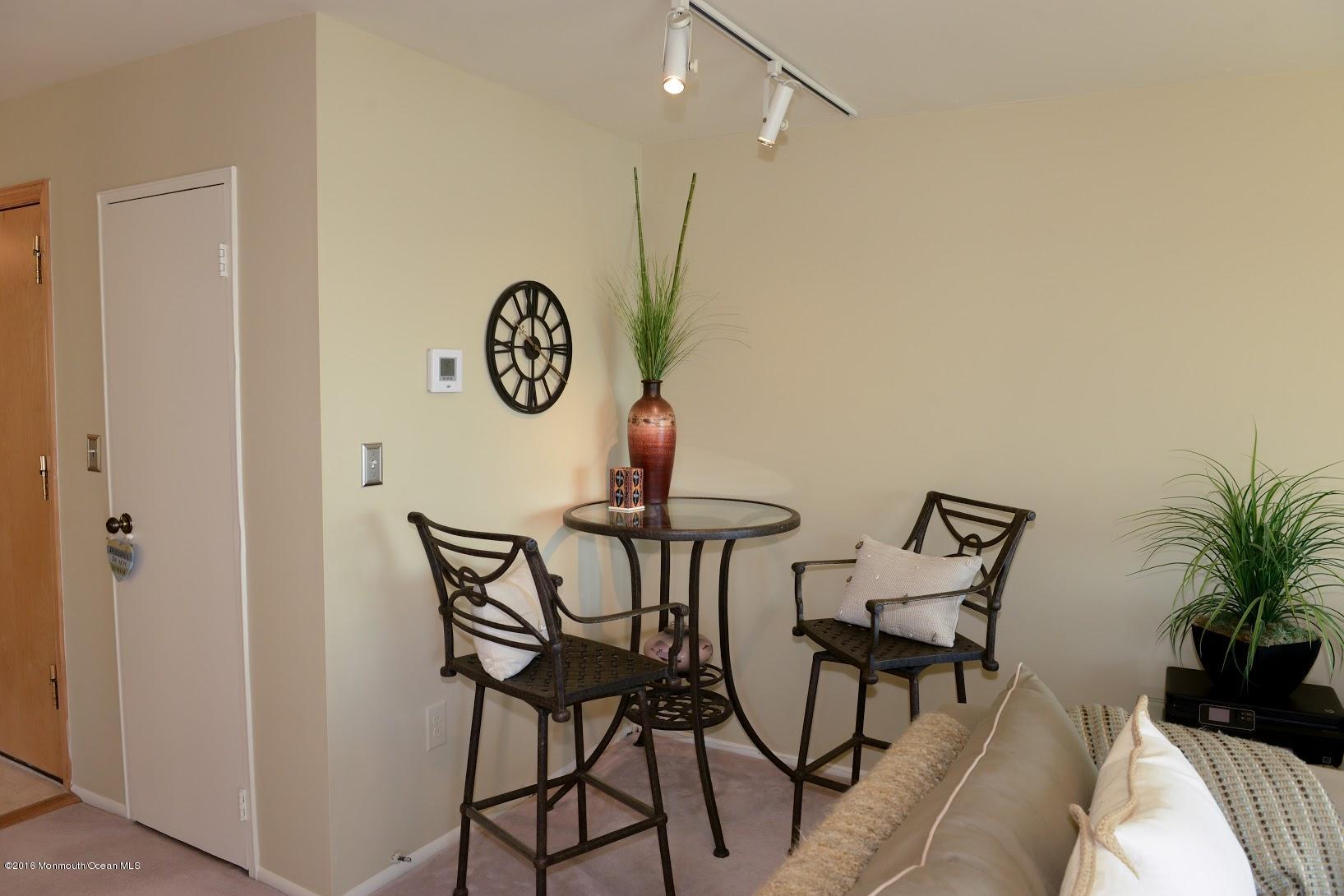 200 Portland Road, Unit A24 Highlands, NJ 07732 - Photo 8 of 30 a view of a dining room with furniture and wooden floor