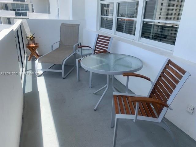 100 Lincoln Road, Unit 1434 Miami Beach, FL 33139 - Photo 8 of 29 a balcony with table and chairs