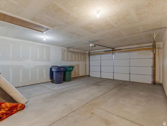 1278 South Grace Way Layton, UT 84041 - Photo 17 of 23 Spacious garage featuring a concrete floor, overhead lighting, and an automatic garage door opener