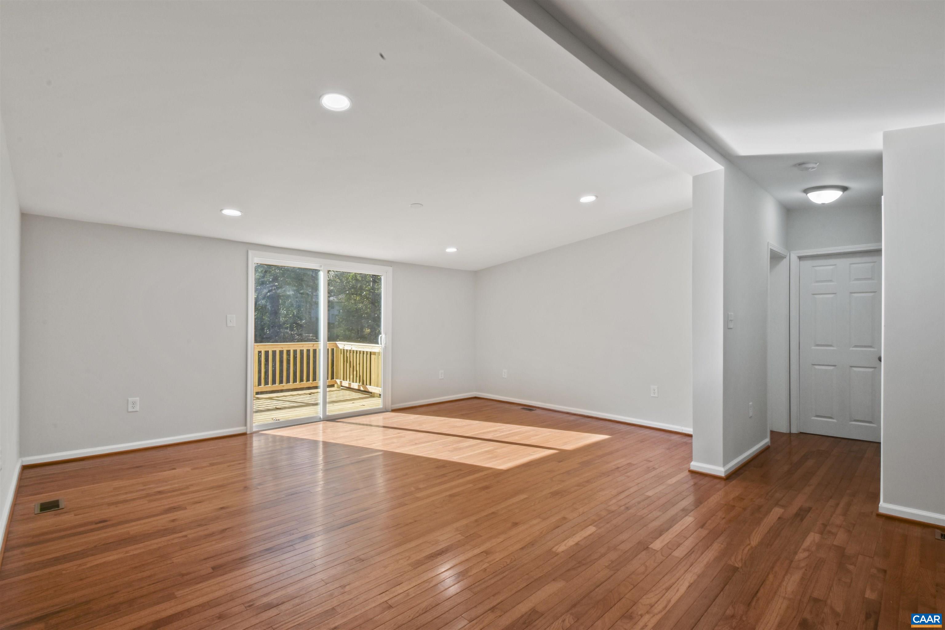 150 Snapdragon Road Ruckersville, VA 22968 - Photo 9 of 26 a view of an empty room with wooden floor and a window