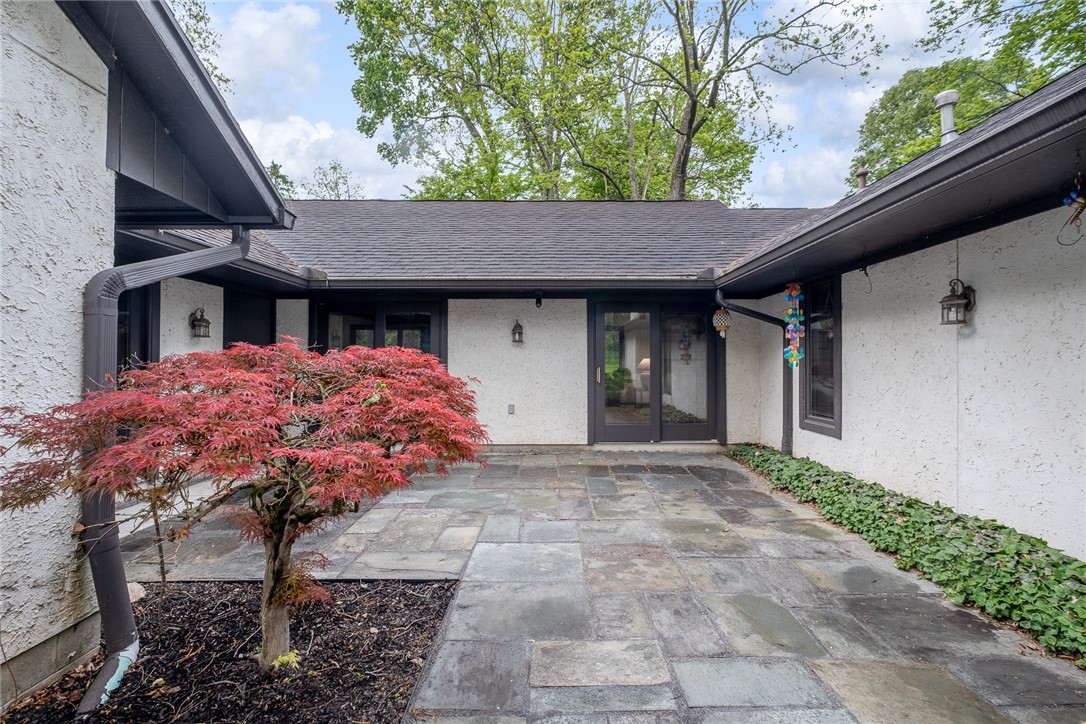 273 North Alpha Bellbrook Road Dayton, OH 45434 - Photo 43 of 43 This private courtyard entry features stone pavers and lush greenery, creating a welcoming approach to the home.