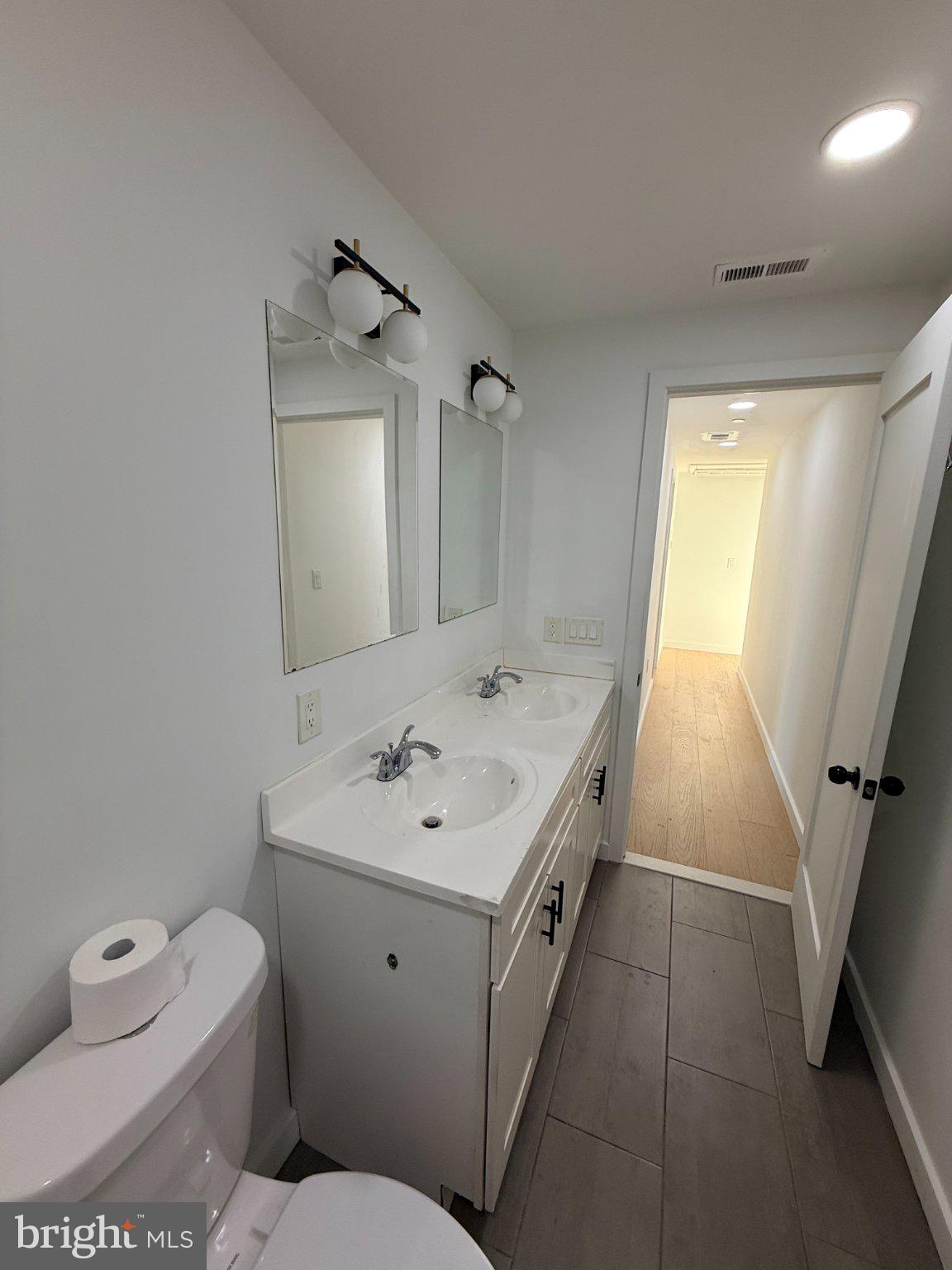 3601 14th Street Northwest, Unit 6 Washington, DC 20010 - Photo 17 of 26 a bathroom with a toilet sink and mirror
