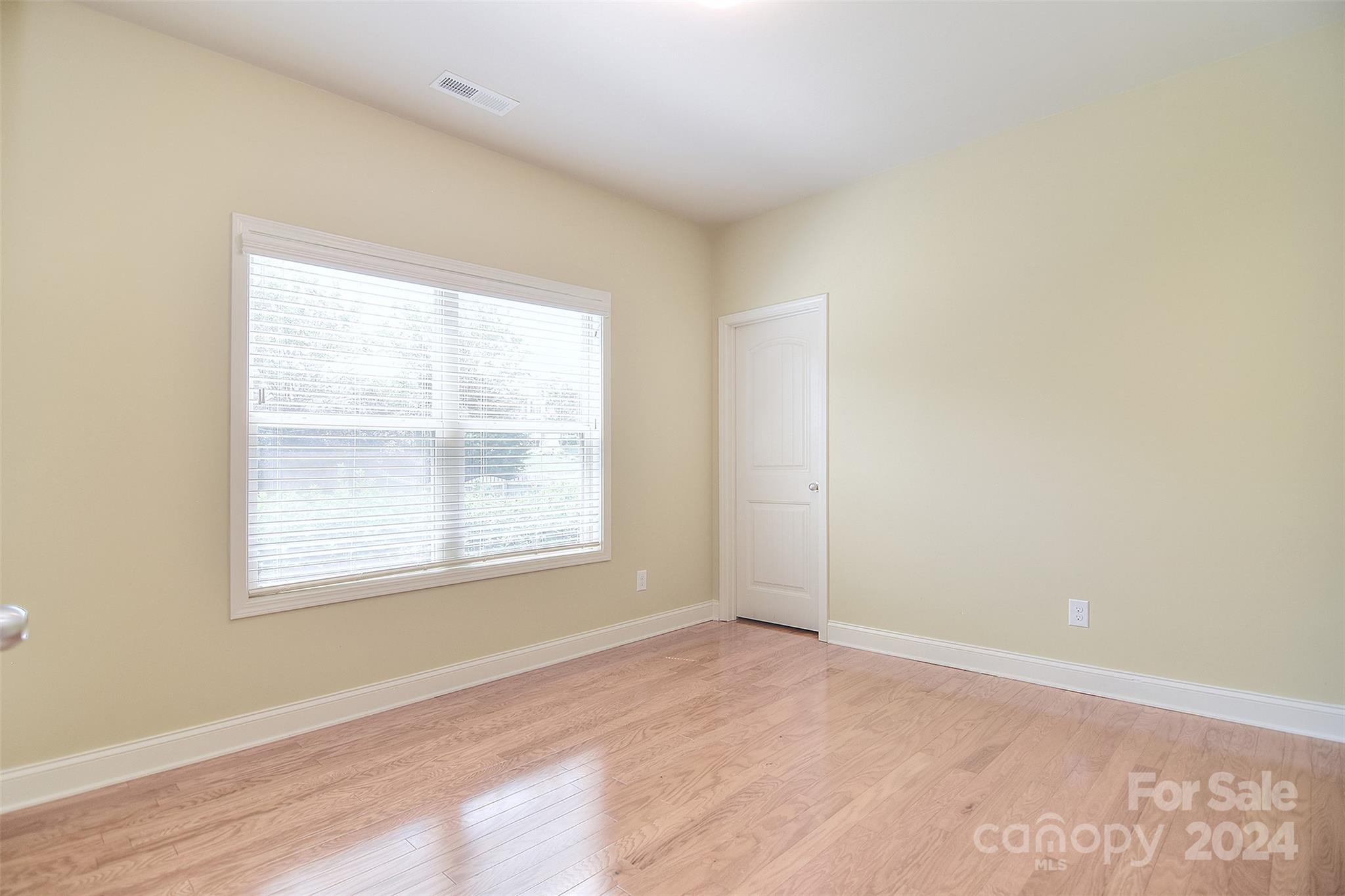 7004 Sedgewick Road Indian Trail, NC 28079 - Photo 12 of 38 an empty room with wooden floor and windows