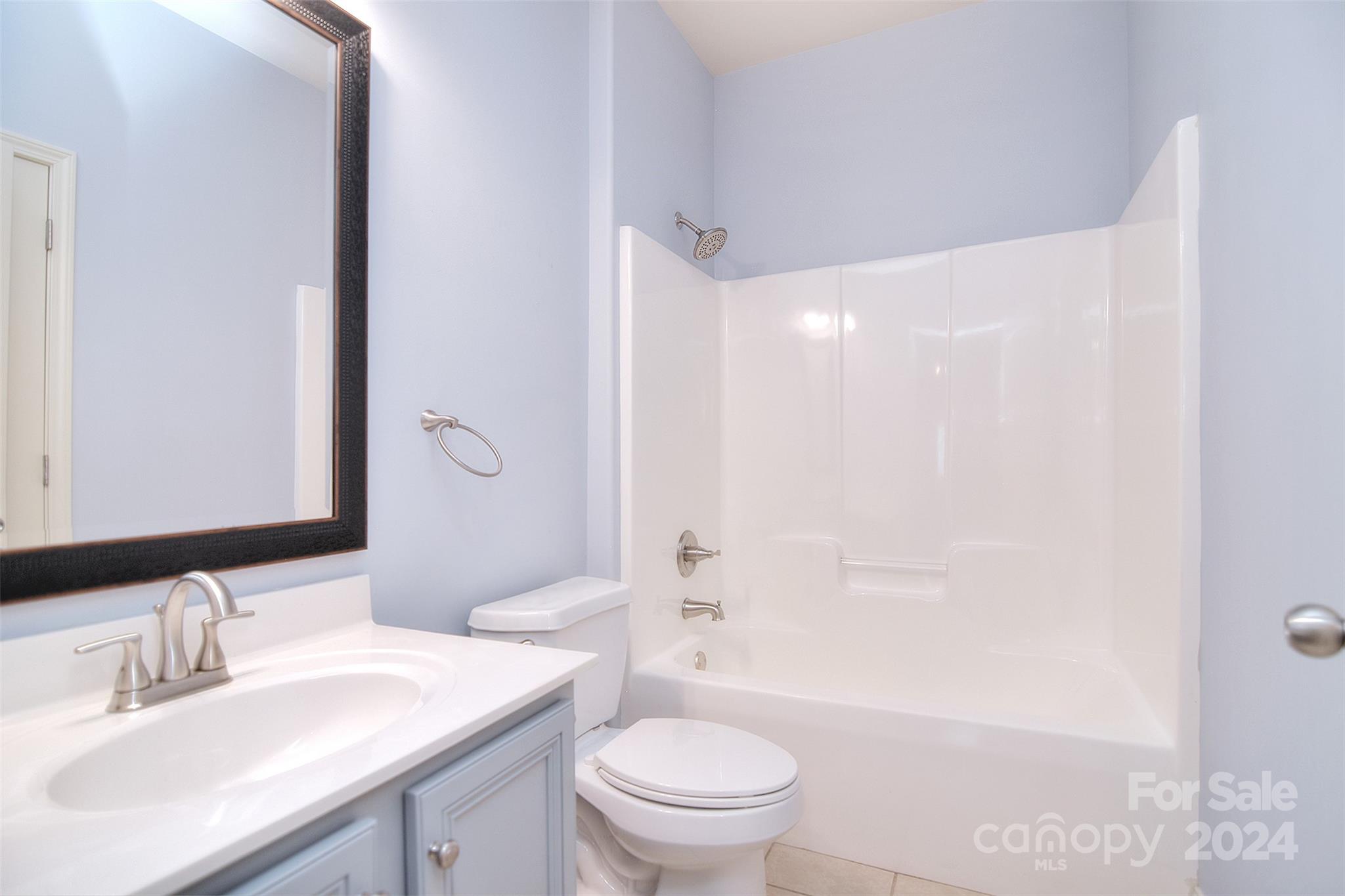 7004 Sedgewick Road Indian Trail, NC 28079 - Photo 13 of 38 a bathroom with a sink a toilet and shower