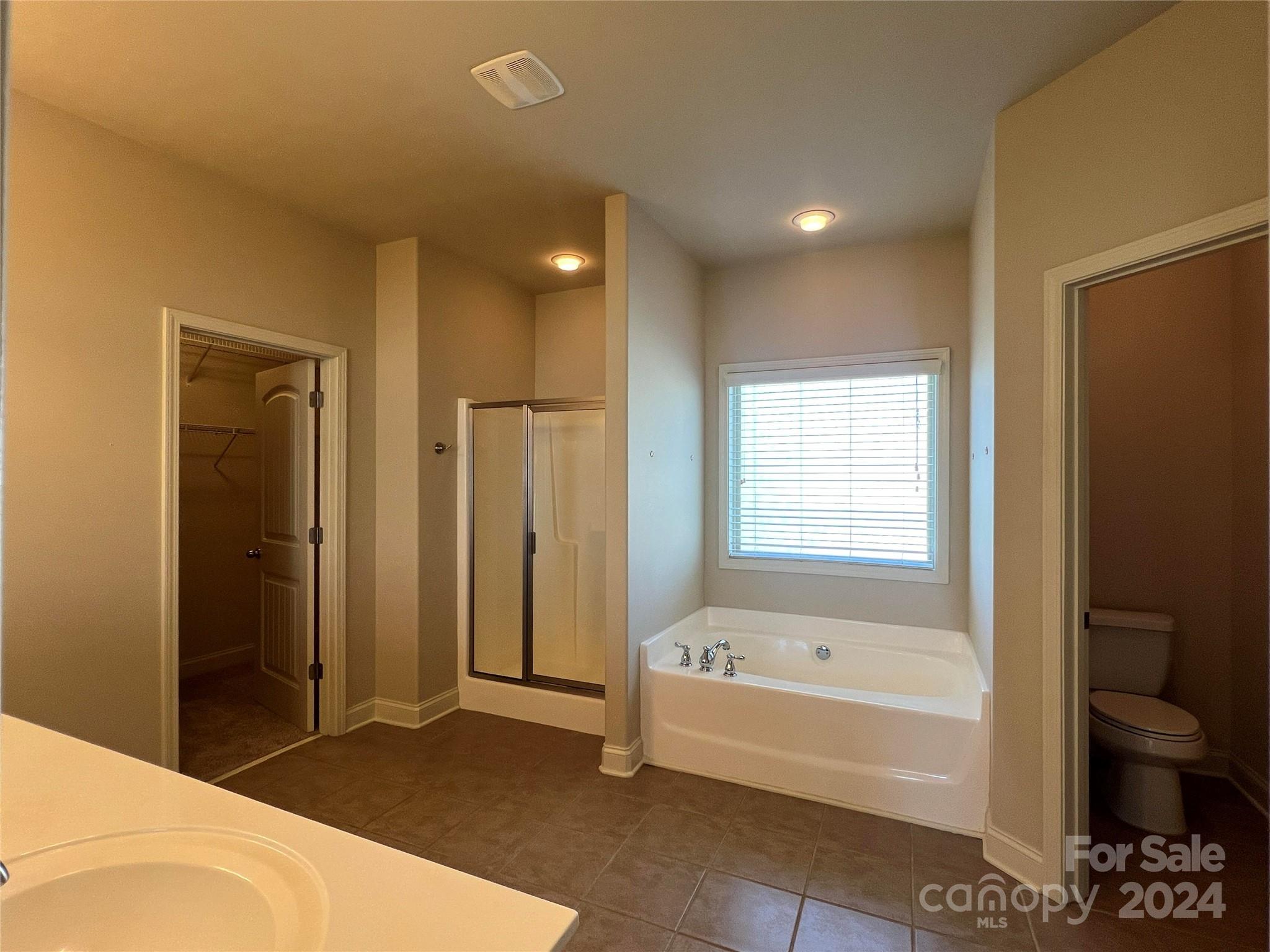 7004 Sedgewick Road Indian Trail, NC 28079 - Photo 18 of 38 a bathroom with a bathtub and a shower