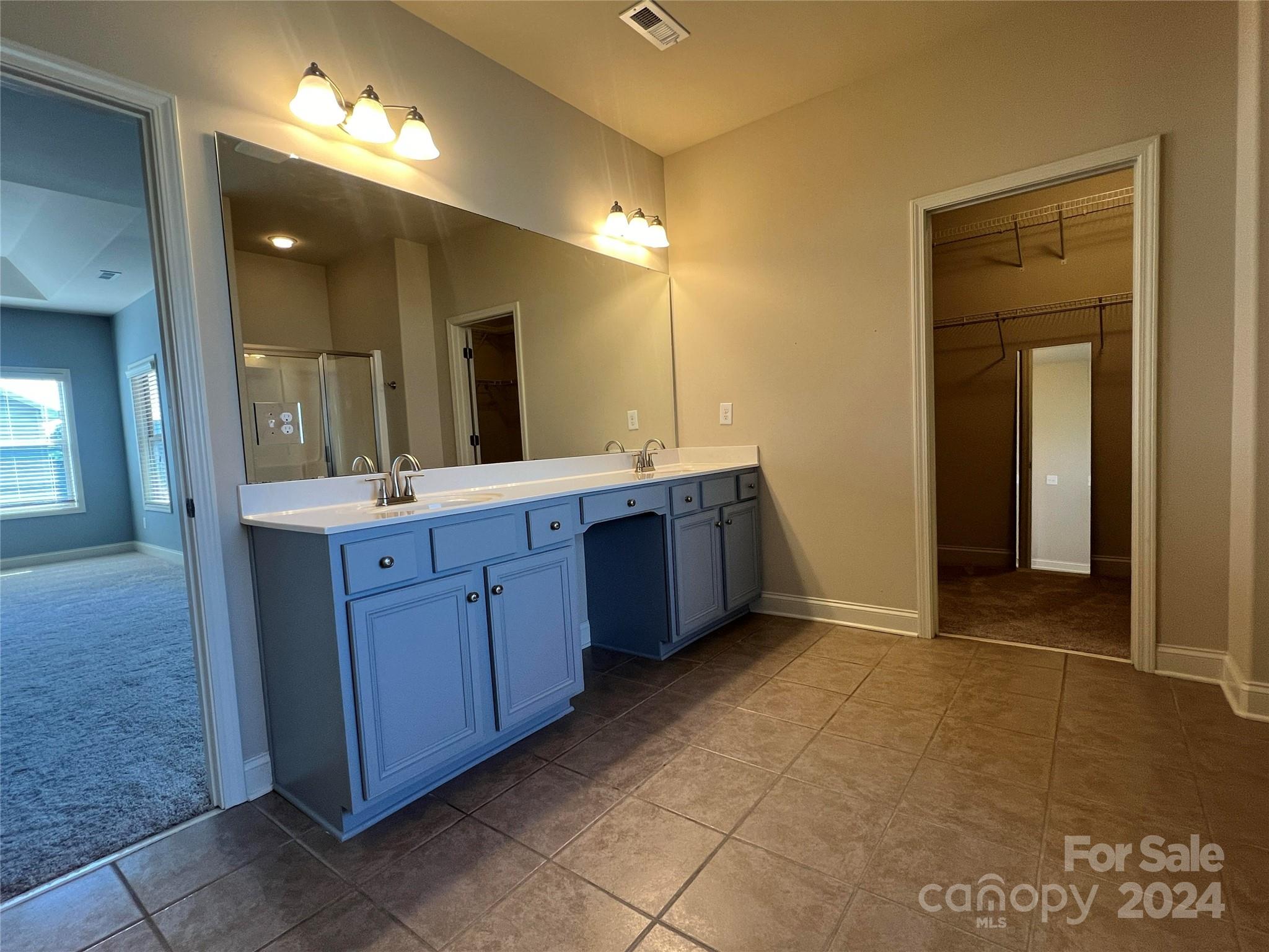 7004 Sedgewick Road Indian Trail, NC 28079 - Photo 19 of 38 a bathroom with a double vanity sink and a mirror