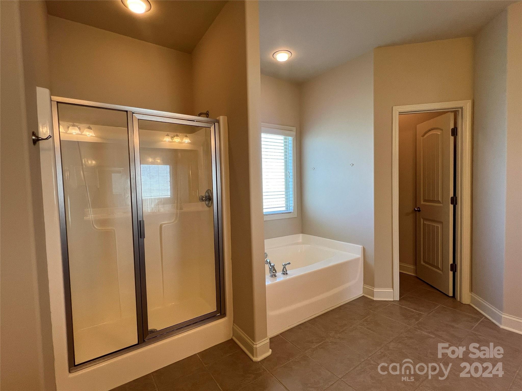 7004 Sedgewick Road Indian Trail, NC 28079 - Photo 20 of 38 a bathroom with a tub and shower