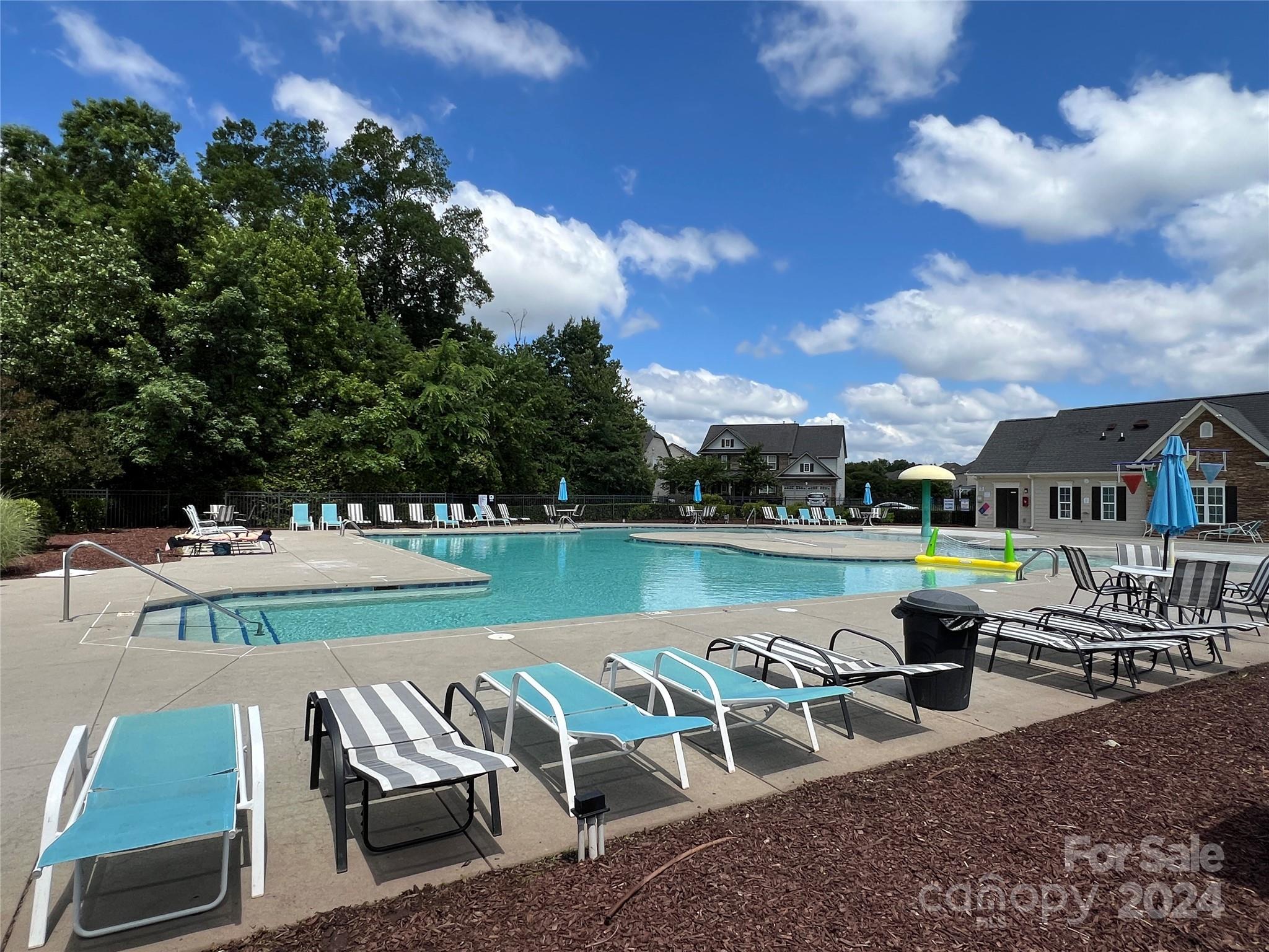7004 Sedgewick Road Indian Trail, NC 28079 - Photo 35 of 38 a view of a swimming pool and lounge chairs in back yard