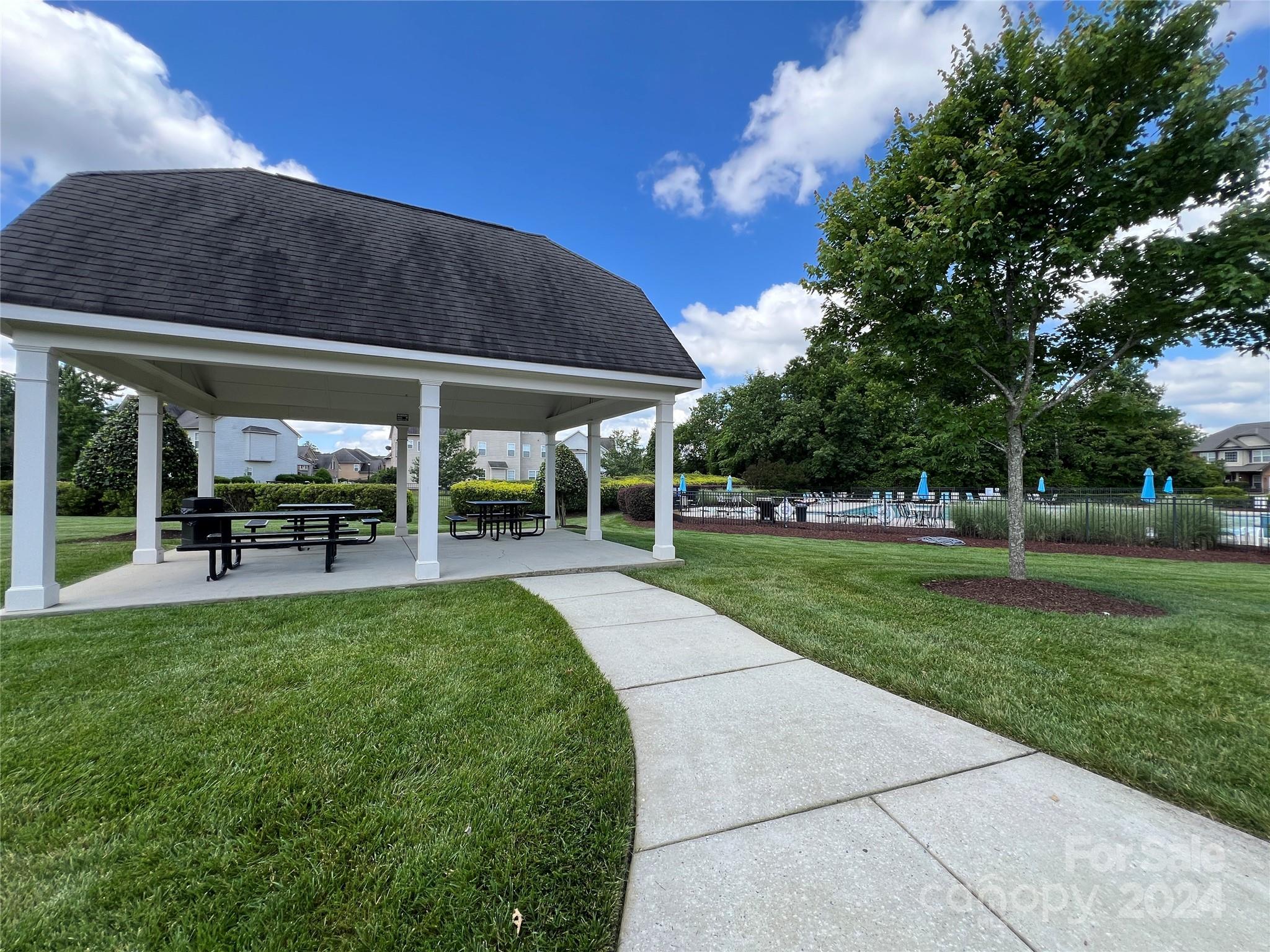 7004 Sedgewick Road Indian Trail, NC 28079 - Photo 36 of 38 a view of a swimming pool with a table and chairs under an umbrella