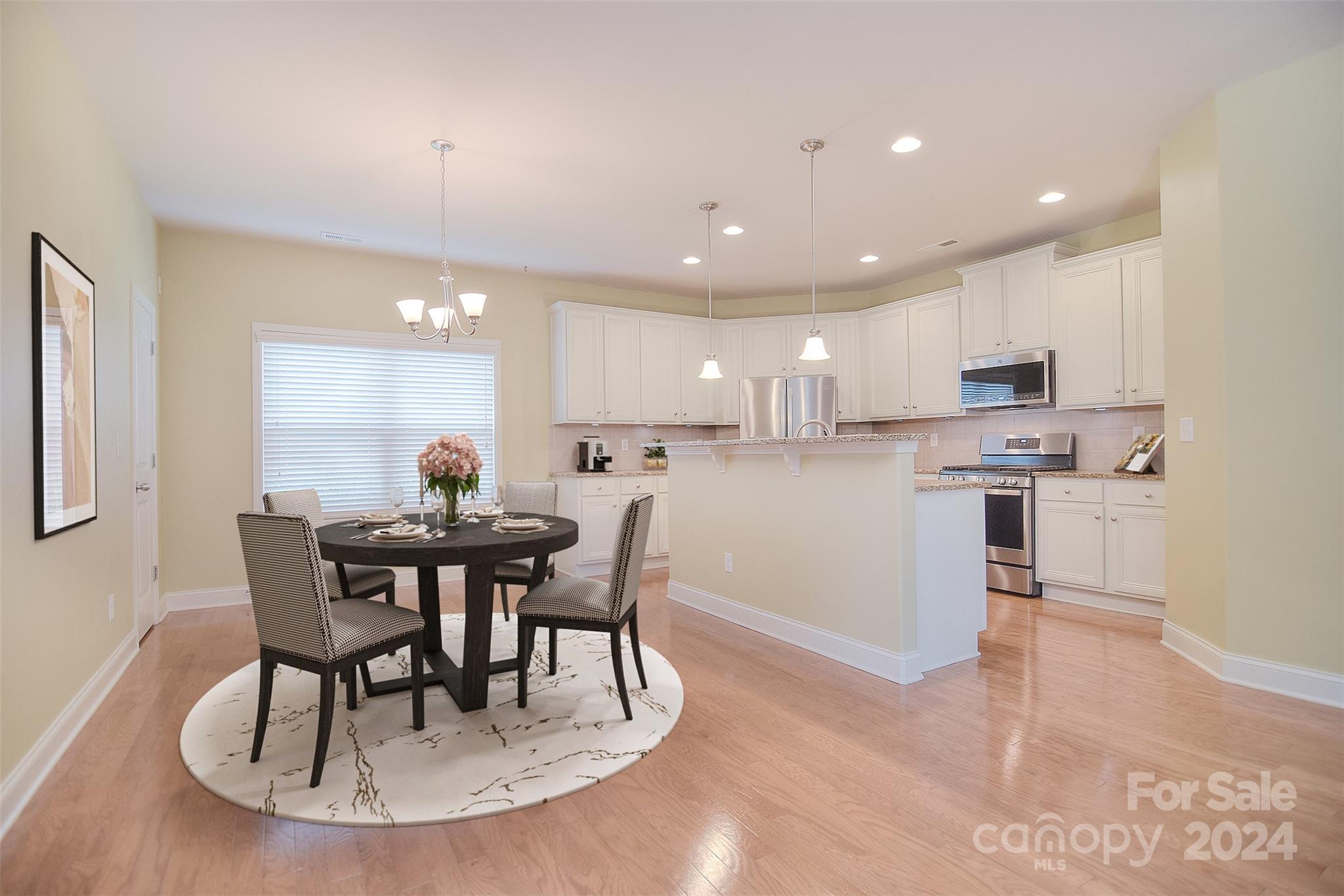 7004 Sedgewick Road Indian Trail, NC 28079 - Photo 7 of 38 a view of a dining room with furniture and wooden floor