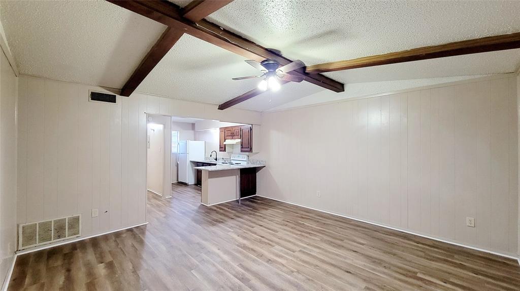 400 Bill Bradford, Unit 13 Sulphur Springs, TX 75482 - Photo 1 of 10 a view of a room with wooden floor and a ceiling fan