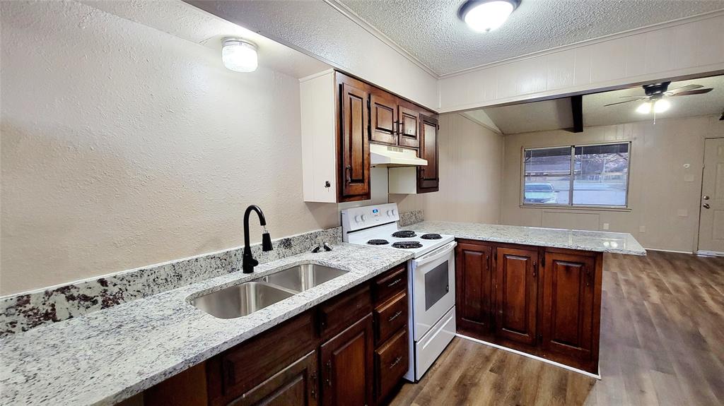 400 Bill Bradford, Unit 13 Sulphur Springs, TX 75482 - Photo 7 of 10 a kitchen with granite countertop a sink and cabinets
