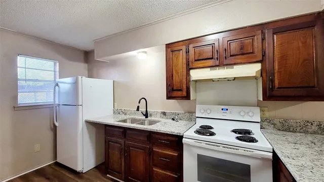 a kitchen with a sink stove and cabinets